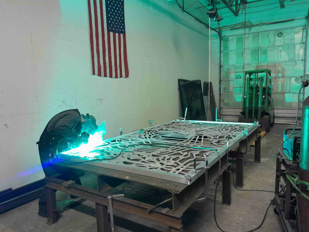 Welding aluminum driveway gates made from metal with scrollwork design for Estero Florida residential community.