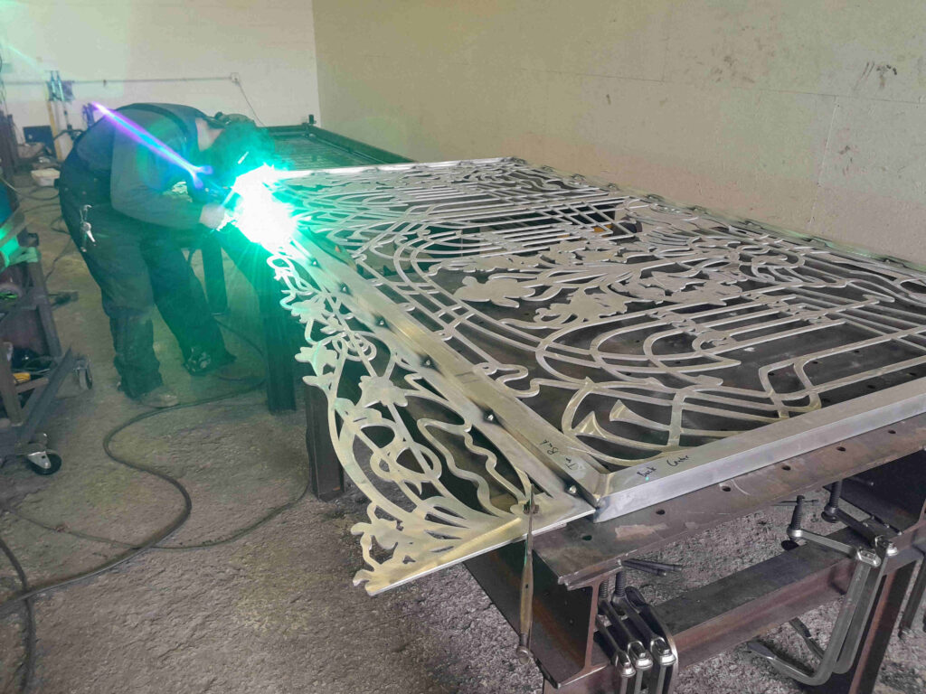 Fabricating aluminum driveway gates made from metal with scrollwork design for Estero Florida residential community.