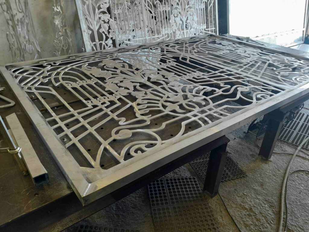 Aluminum driveway gates made from 1/4" sheet metal plate with scrollwork design for Estero Florida residential community.