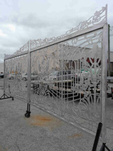 Two aluminum driveway gates made from metal with scrollwork design for Estero Florida residential community.