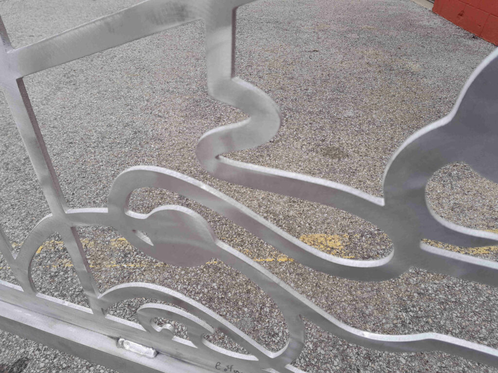 Aluminum scroll driveway gates made from metal with scrollwork design for Estero Florida residential community.