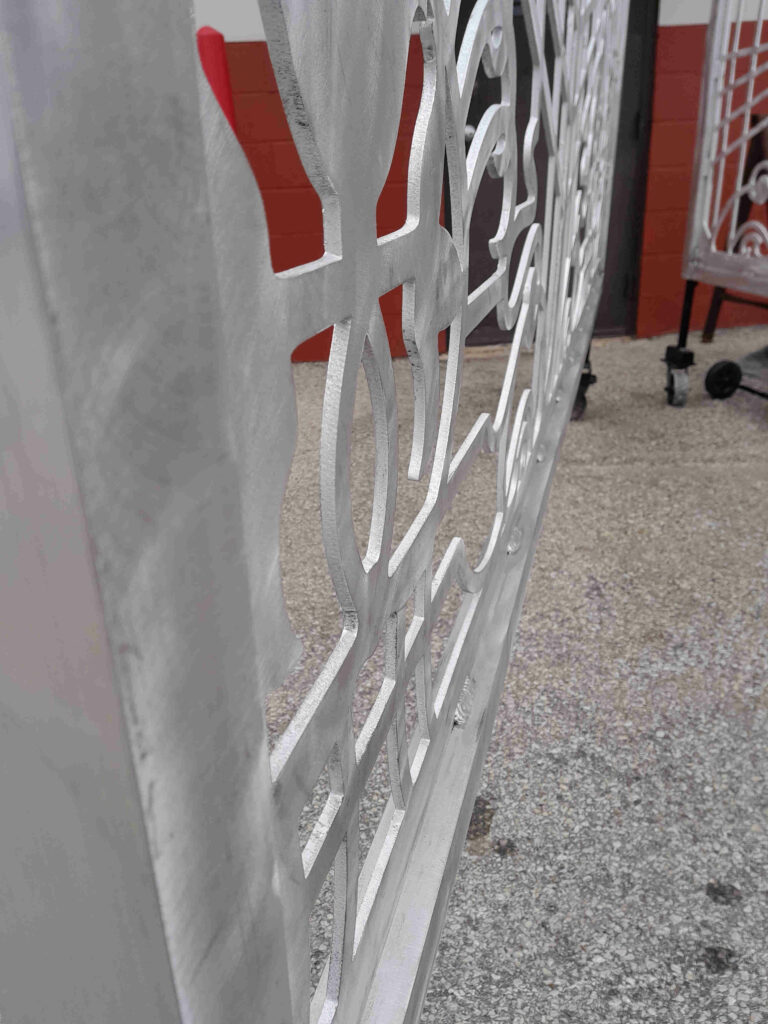 Plasma cut aluminum driveway gates made from metal with scrollwork design for Estero Florida residential community.