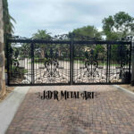 Driveway gates for Estero, FL property entrance at Club at Rapallo. Aluminum gate with decorative scrolls is plasma cut with a black powder coated finish.
