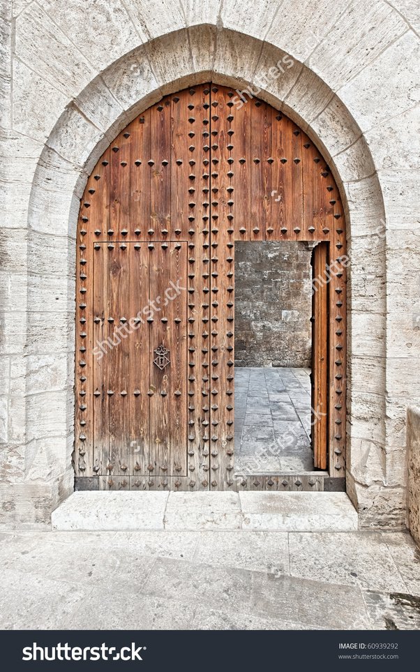 Picture of medieval wooden driveway gate at an arched entrance.
