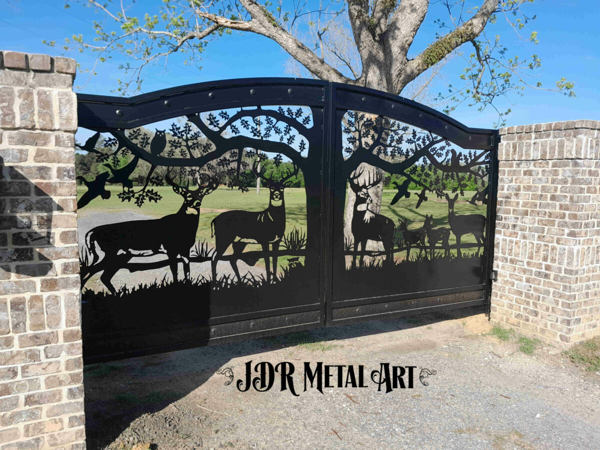 Driveway gates with wildlife design featuring whitetail buck deer, mule deer, fawns, a doe, ducks, a raccoon and an oak tree.