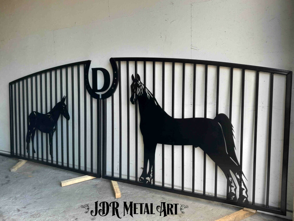 Metal farm driveway gate design with horses for a horse farm.