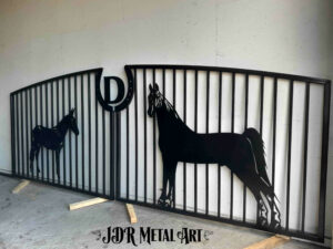 Metal farm driveway gate design with horses for a horse farm.