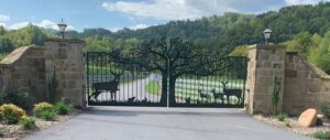 Custom driveway gates installed to stone columns for entry gate