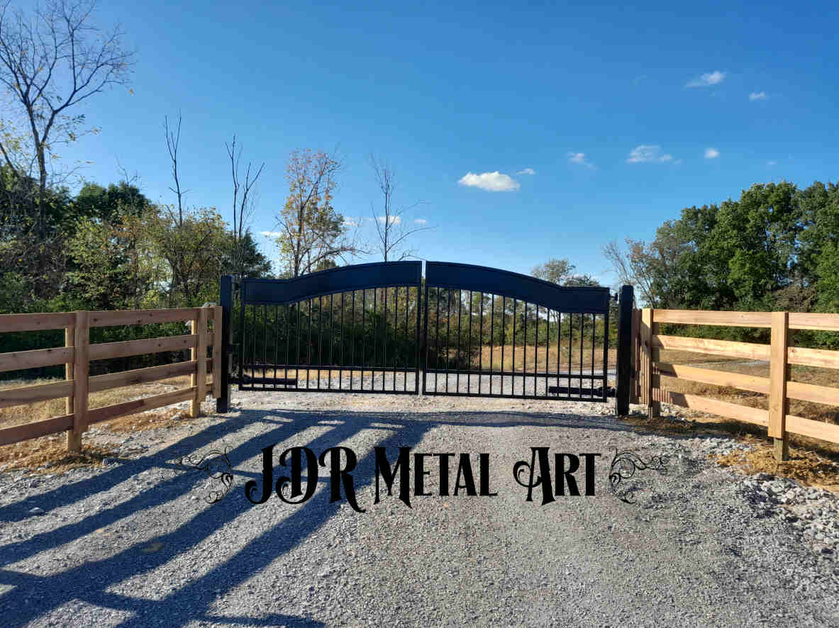 Black driveway gates securing Louisville, Kentucky property with Kentucky 4 board fence attached to the gate posts.