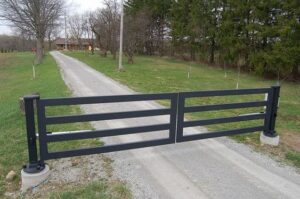 Driveway gate design idea with simple rectangle design, flat top, 4 board fence style made from steel or aluminum or wrought iron.