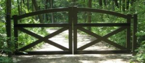 Driveway gate design idea with arched top frame, dual swing, heavy duty rectangular tube frame custom made with crossbucks.