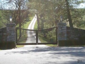 Custom driveway gate design idea with arched top, pickets made from steel and aluminum.