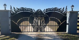 Driveway gate design idea with horses plasma cut or laser cut into a silhouette for entry gate made from steel or aluminum or perhaps iron, hung from stone columns.