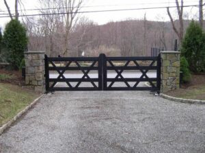 Driveway gate design with heavy duty tubing, x style braces, stone columns.