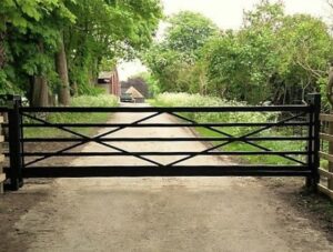 A metal driveway gate design idea for home security at the property entrance.