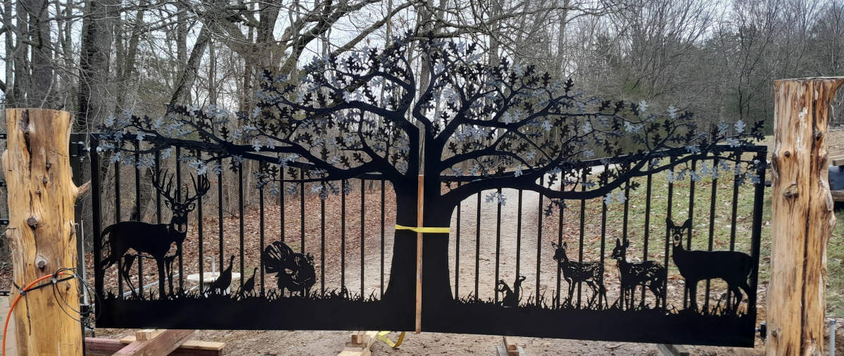 Indianapolis driveway gates with oak tree gate design, deer, a squirrel, turkeys and cedar wood posts.