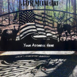 An Atlanta steel driveway gate with an arched top and two 6x6 gate posts. The gate design idea includes wildlife such as whitetail deer, a black bear, a bald eagle, a flag and the North Georgia mountains in the background of the scene.