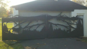 custom driveway gate with elk wolf moon clouds mountains and eagle