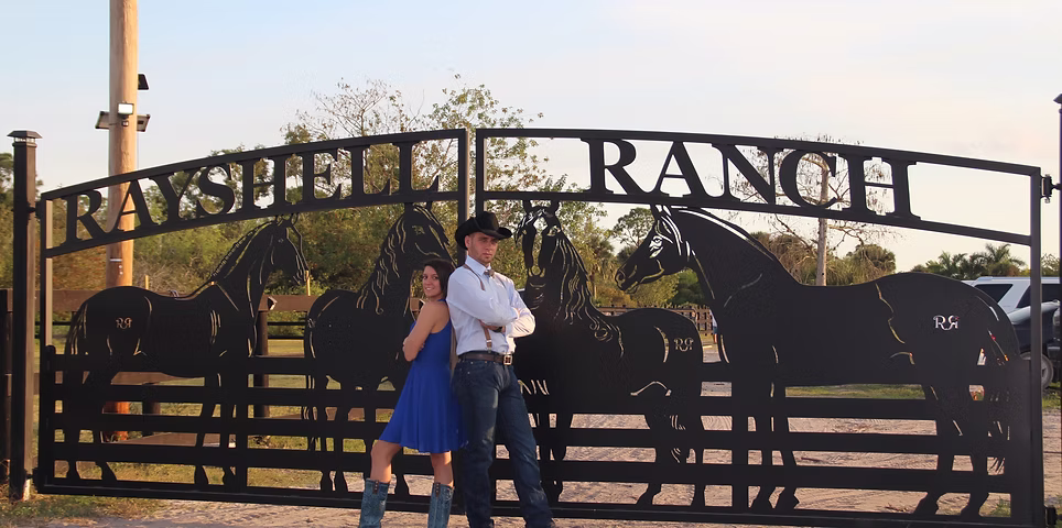 Custom driveway gate made from aluminum in Palm Beach County Area of Florida. We designed and built this for a client, a wedding venue called Rayshell Ranch, which is near Boca Raton. Custom metal art driveway gate in Palm Beach County Florida, manufactured by JDR Metal Art in 2019. This gate is made from aluminum, is 7' tall and has a double arched design featuring four beautiful metal art plasma cut horses.