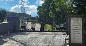 These driveway gates in Nashville TN feature a tree gate design with wildlife including deer and turkeys, guards the entrance to a farm along the Harpeth River. They are mounted to brick columns and powder coated black. The gate design was created by JDR Metal Art in 2025.