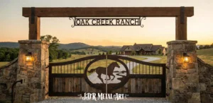 Creative Ranch Gate Ideas 1 A creative ranch gate idea with custom metal and wood ranch gate with a horse silhouette and 'OAK CREEK RANCH' text, set in stone pillars at sunset.