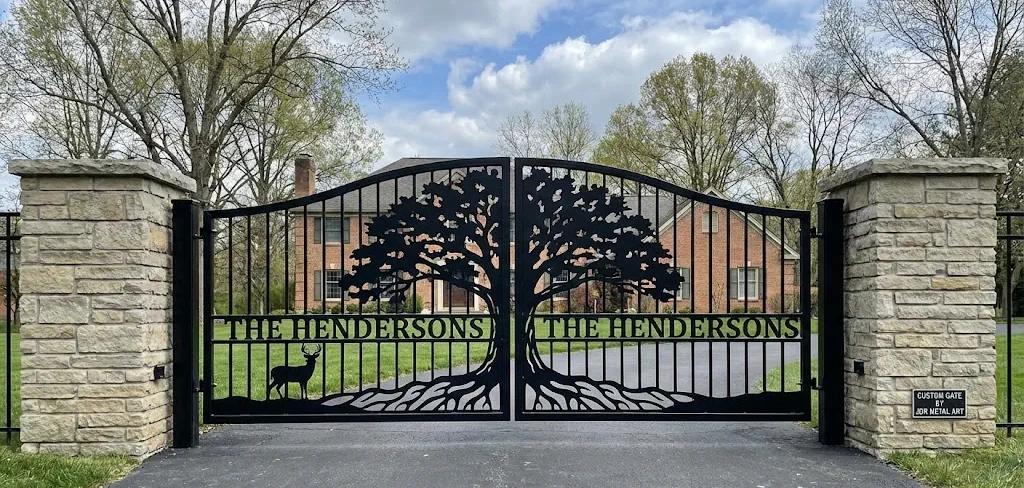 Custom Tree and Deer Driveway Gate in Cincinnati Custom laser cut metal driveway gate installed in a Cincinnati, Ohio suburb, featuring a large oak tree, deer, and personalized name 'THE HENDERSONS' by JDR Metal Art.
