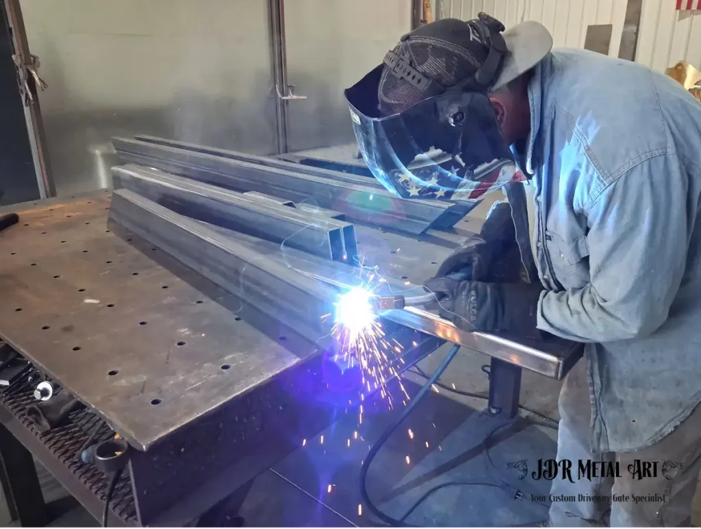 Knoxville TN Custom Driveway Gates | JDR Metal Art (Horse Theme, Steel Frame & Rough Sawn Cedar) 4 Welder fabricating steel frame for custom driveway gate at JDR Metal Art in Knoxville, TN