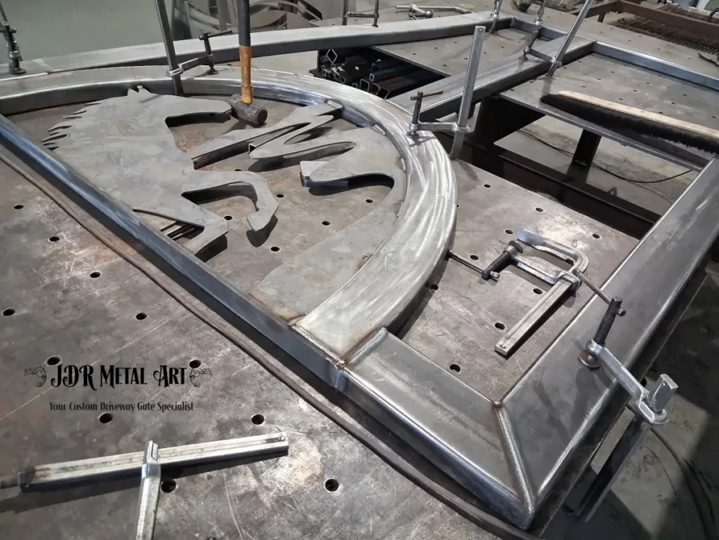 Knoxville TN Custom Driveway Gates | JDR Metal Art (Horse Theme, Steel Frame & Rough Sawn Cedar) 2 Steel horse head and mane silhouette clamped and welded during custom gate fabrication for Knoxville, TN property entrance gate.